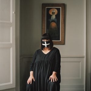 Women in mask dressed black